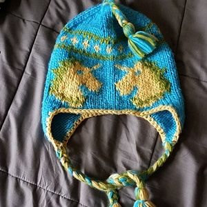 Knitted unicorn hat yellow blue and green